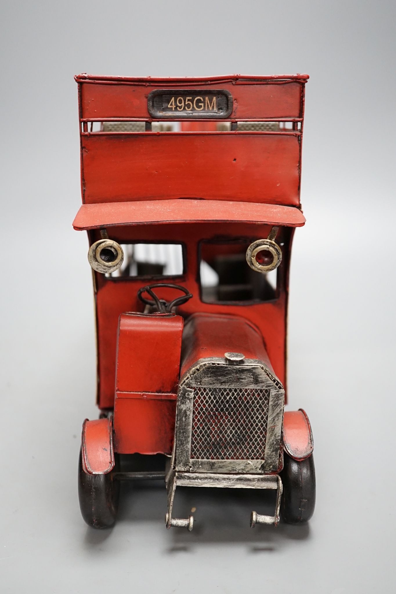 A reproduction tinplate double decker topless bus, the side reading ‘Don’t be vague - ask for Haig’, 42cm long